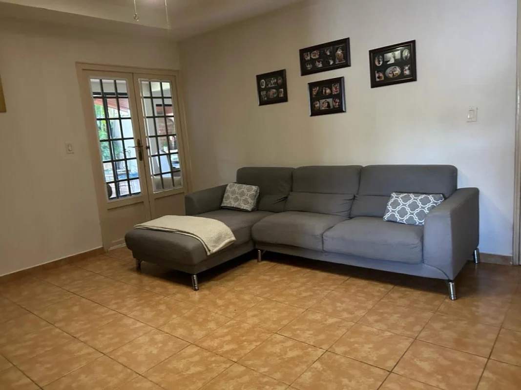 Covered carport tiled floors pedestrian walkway fenced Villa Zaita Panama