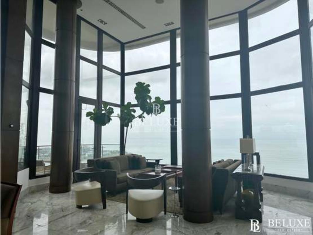 Modern open kitchen with granite countertops, central island, wood cabinetry in PH Regent Penthouse Panama