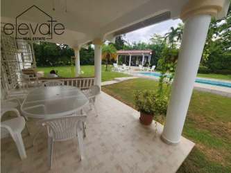 Functional kitchen with wood cabinets, tile floor, and dining space at Coronado beach house.