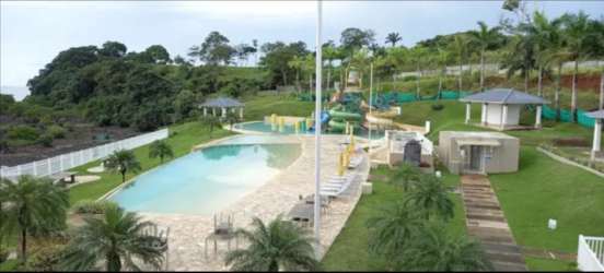 Minimalist kitchen with granite countertops and wood cabinets in Playa Dorada house for sale Panama