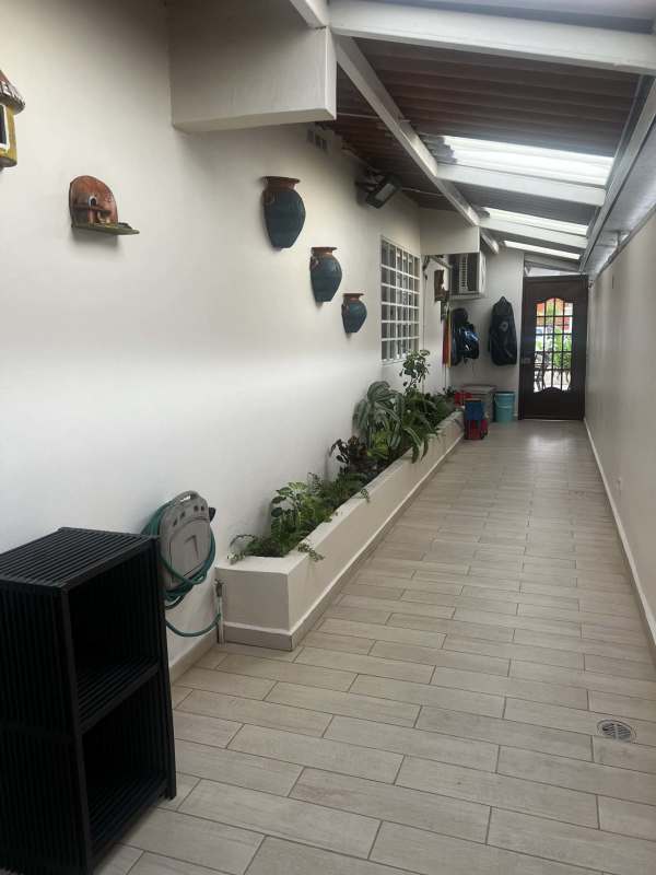 Spacious living room with large windows and tiled floors at Villa Serena Panama City