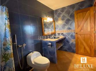 Rustic bathroom with blue tiles, walk-in shower, large mirror in beach villa Costa Coronado