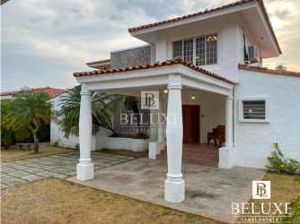 Spacious bedroom with tiled floor, large windows, AC, sofa and queen bed in Coronado villa