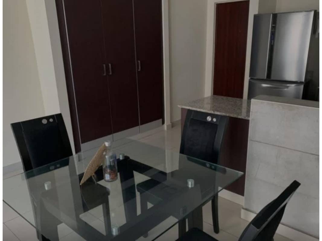 Glass dining table next to granite kitchen counter at PH Vitro Panama City