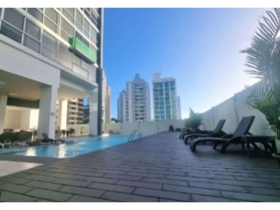 Rooftop pool area with lounge chairs and skyline views at PH Vitro El Cangrejo Panama