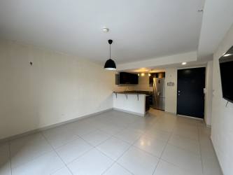 View of PH Midrise condo building with covered parking in Panama Pacifico