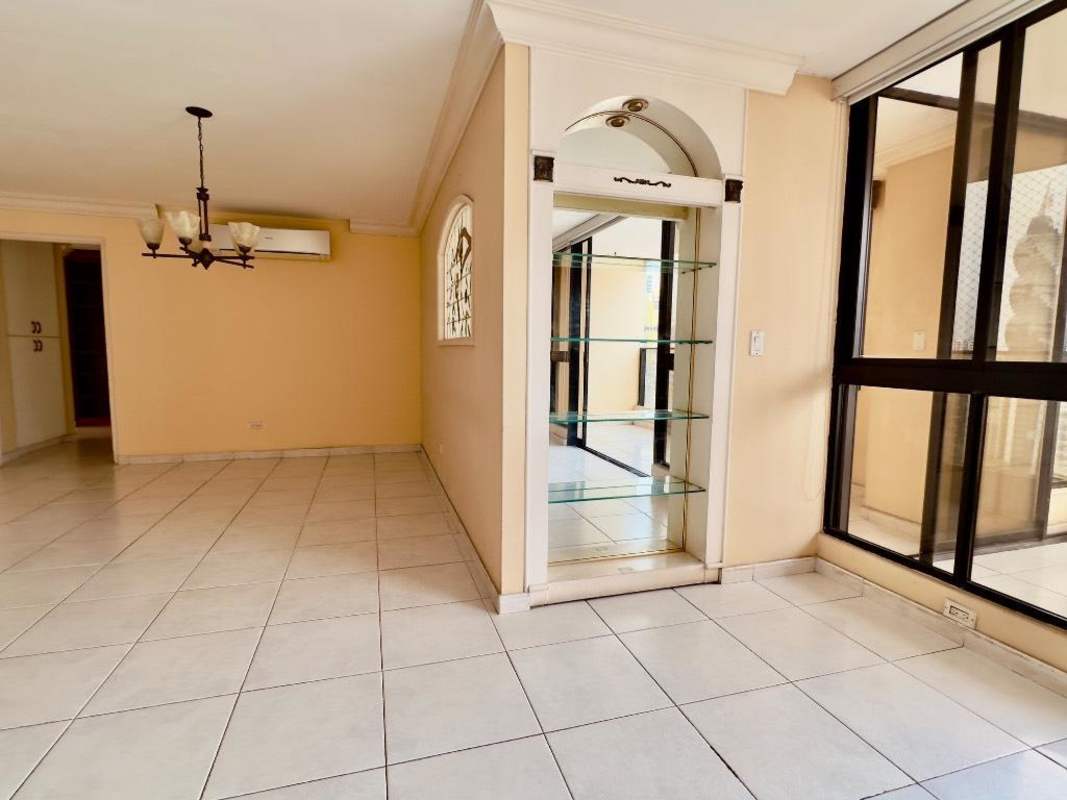Large living and dining room space with windows and balcony view at PH La Fontana Obarrio Panama City