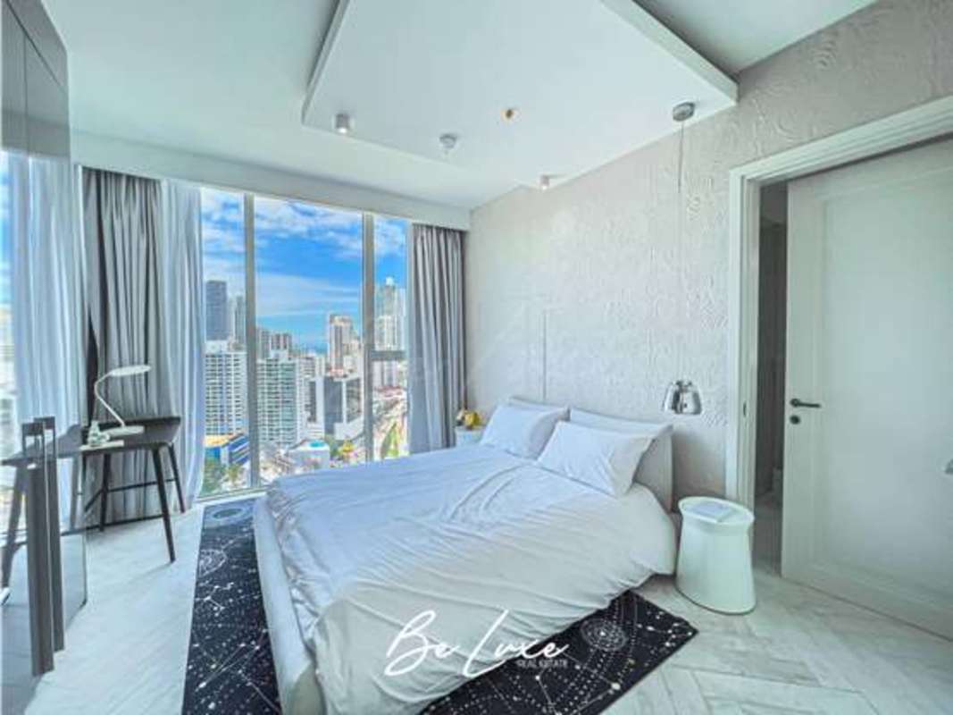 Modern condo workspace with large city skyline window view at PH Wanders & Yoo