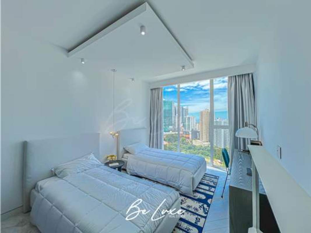 Bedroom with floor-to-ceiling windows and skyline views PH Wanders & Yoo Panama City