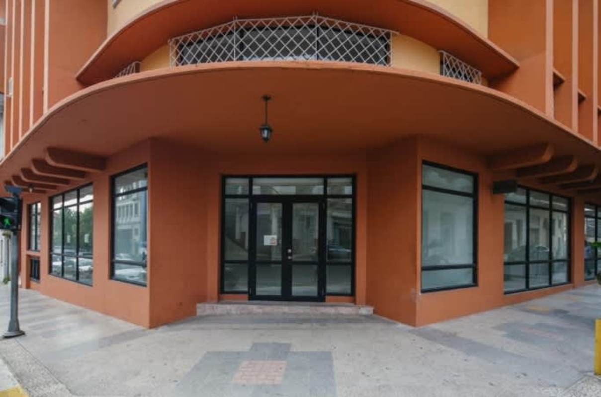 Curved corner commercial storefront with large glass windows in Art Deco heritage building Casco Viejo Panama