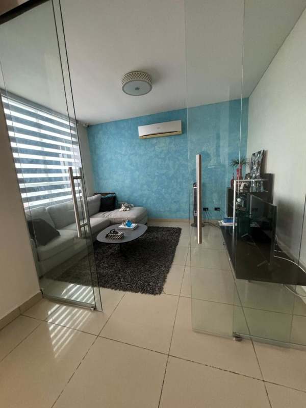 Modern living room with panoramic windows, sectional sofa, city ocean views in PH Mandarin Bay Panama