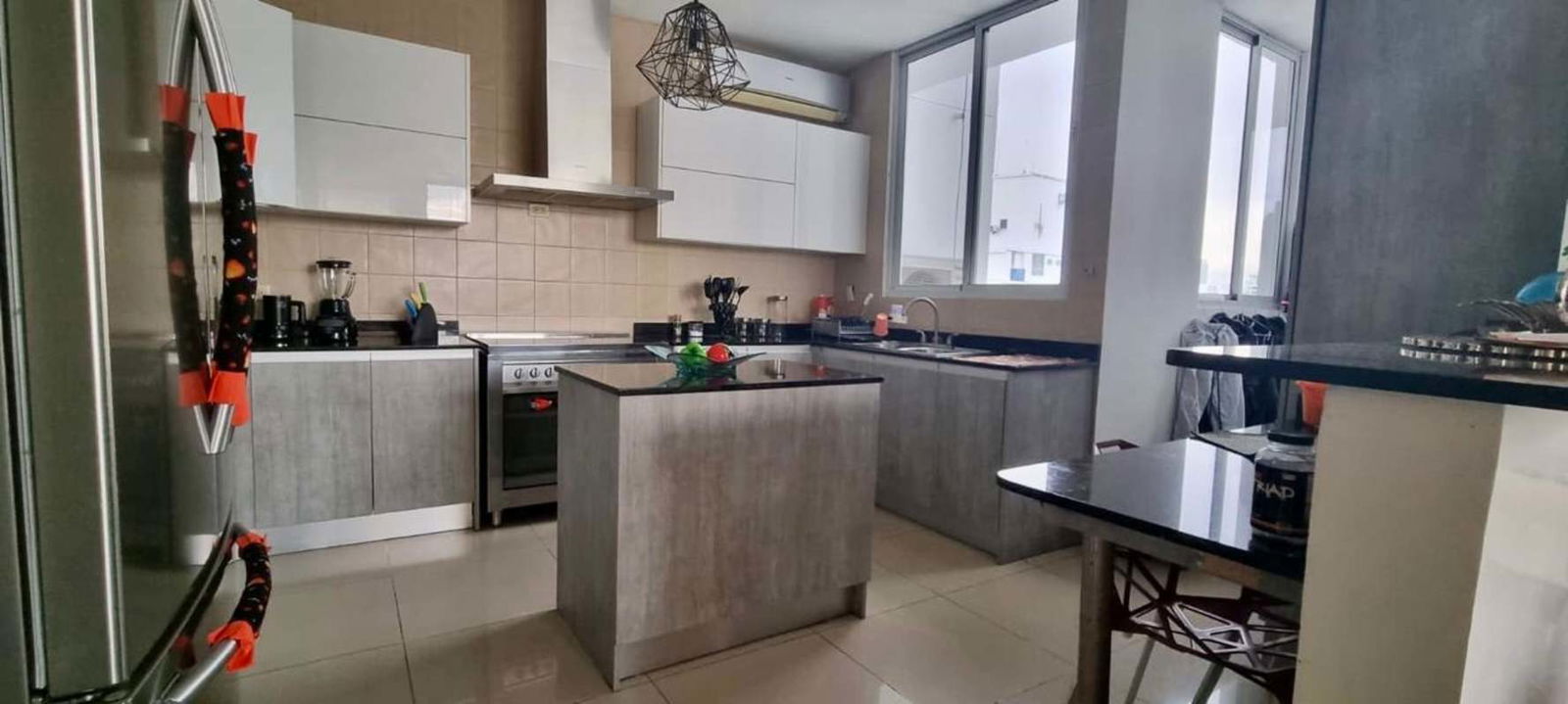 Gray cabinetry kitchen with island, large windows PH Mandarin Bay in San Francisco Panama City
