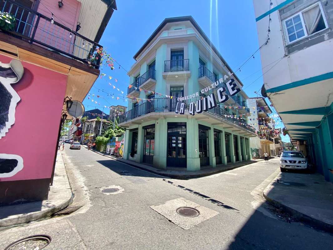 Restored colonial corner building with colorful balconies and street art in Santa Ana La Quince Panama City