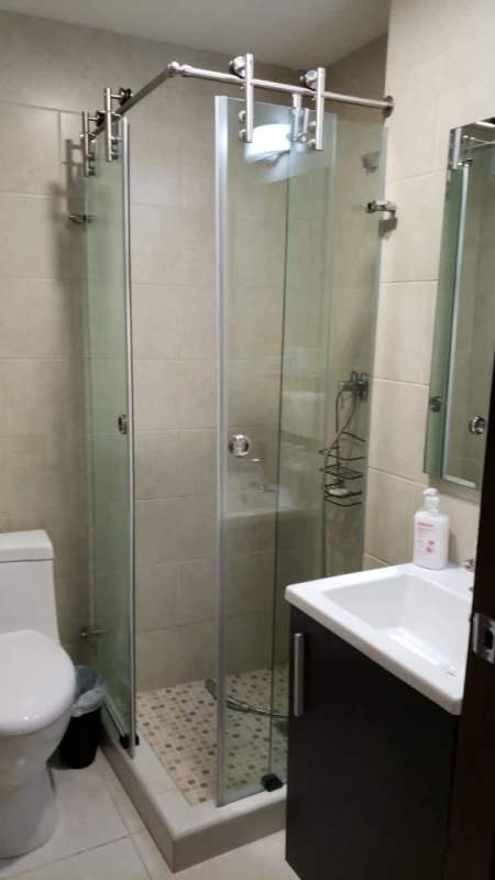 Bathroom with glass corner shower, vanity, contemporary tiles in PH Bay View Tower Panama City