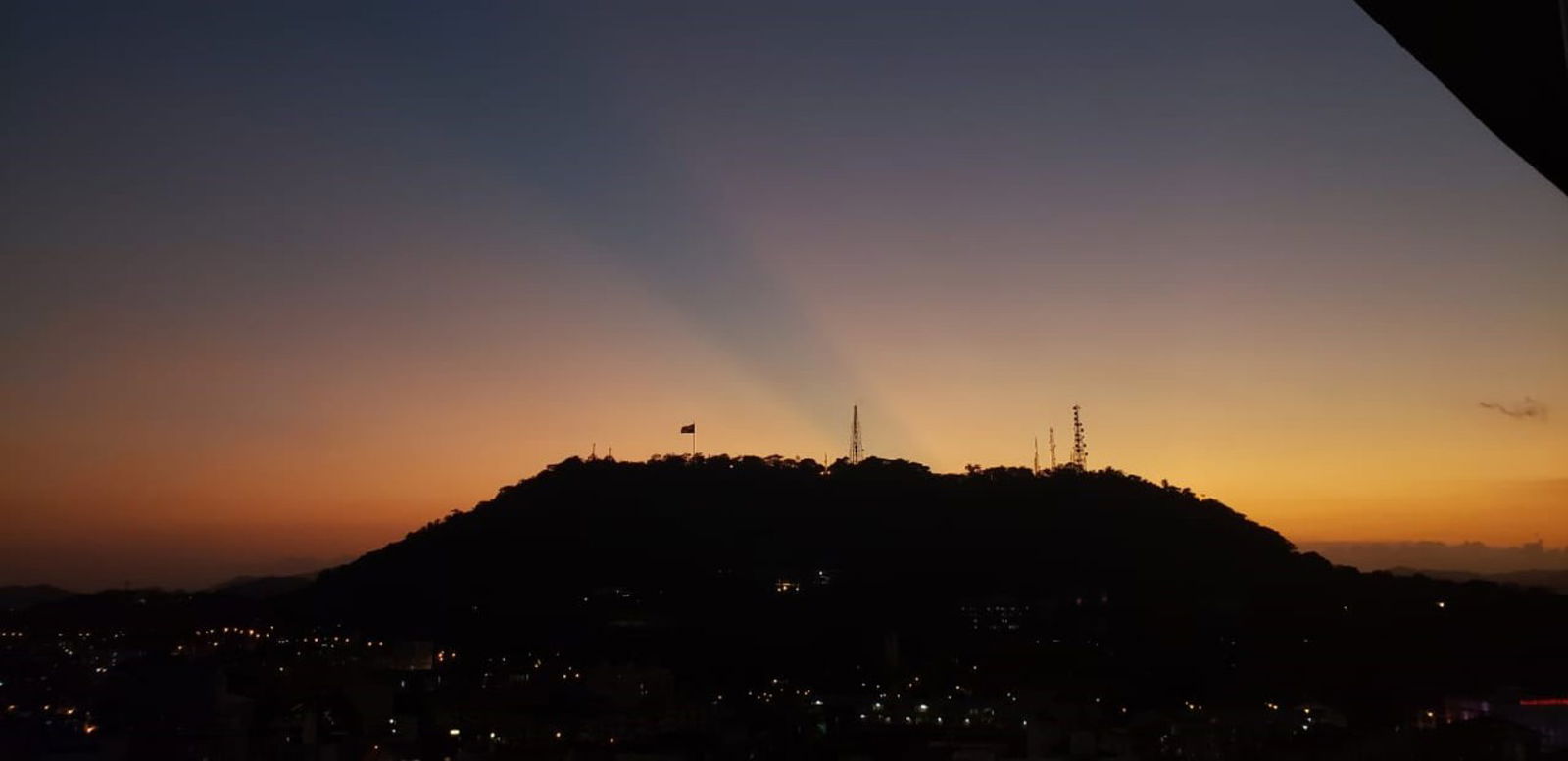 Spectacular sunset behind Cerro Ancón seen from Bay View Tower in Panama City