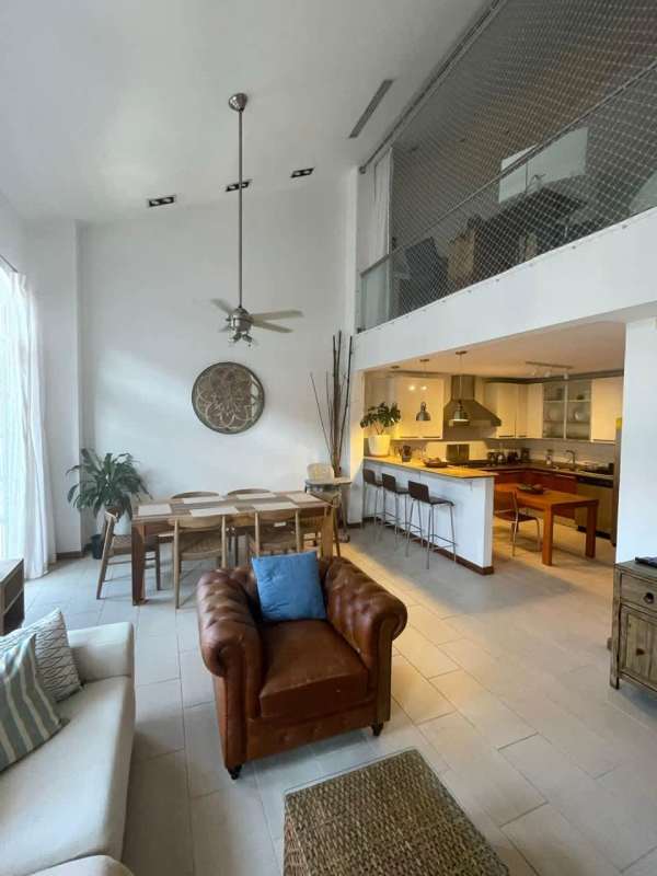 Open plan loft apartment double-height ceiling kitchen dining Casco Viejo Panama