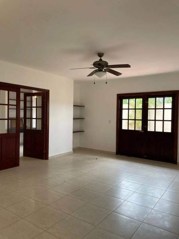 Spacious living room with French doors, ceiling fan and tiled floor at Villa Valencia Costa Sur