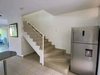 Private garden tiled terrace outdoor seating area next to pool in Bahia Residences Panama