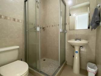 Modern kitchen with granite countertops gas stove microwave backsplash in beach apartment Panama