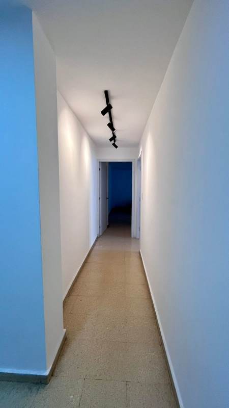 Minimalist living space with sectional sofa and city view PH Liz Marie San Francisco Panama