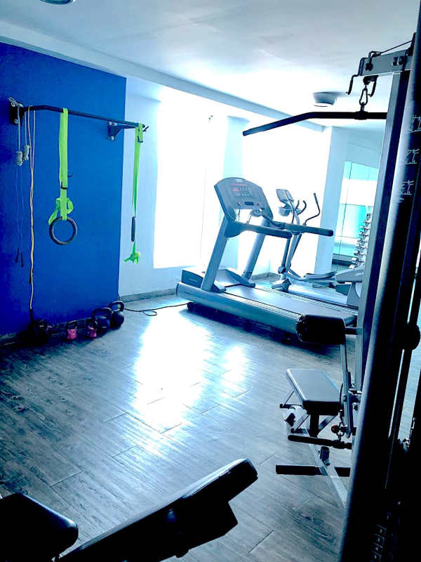 Open modern kitchen with granite countertops and stainless steel appliances in Icon Tower Coco del Mar