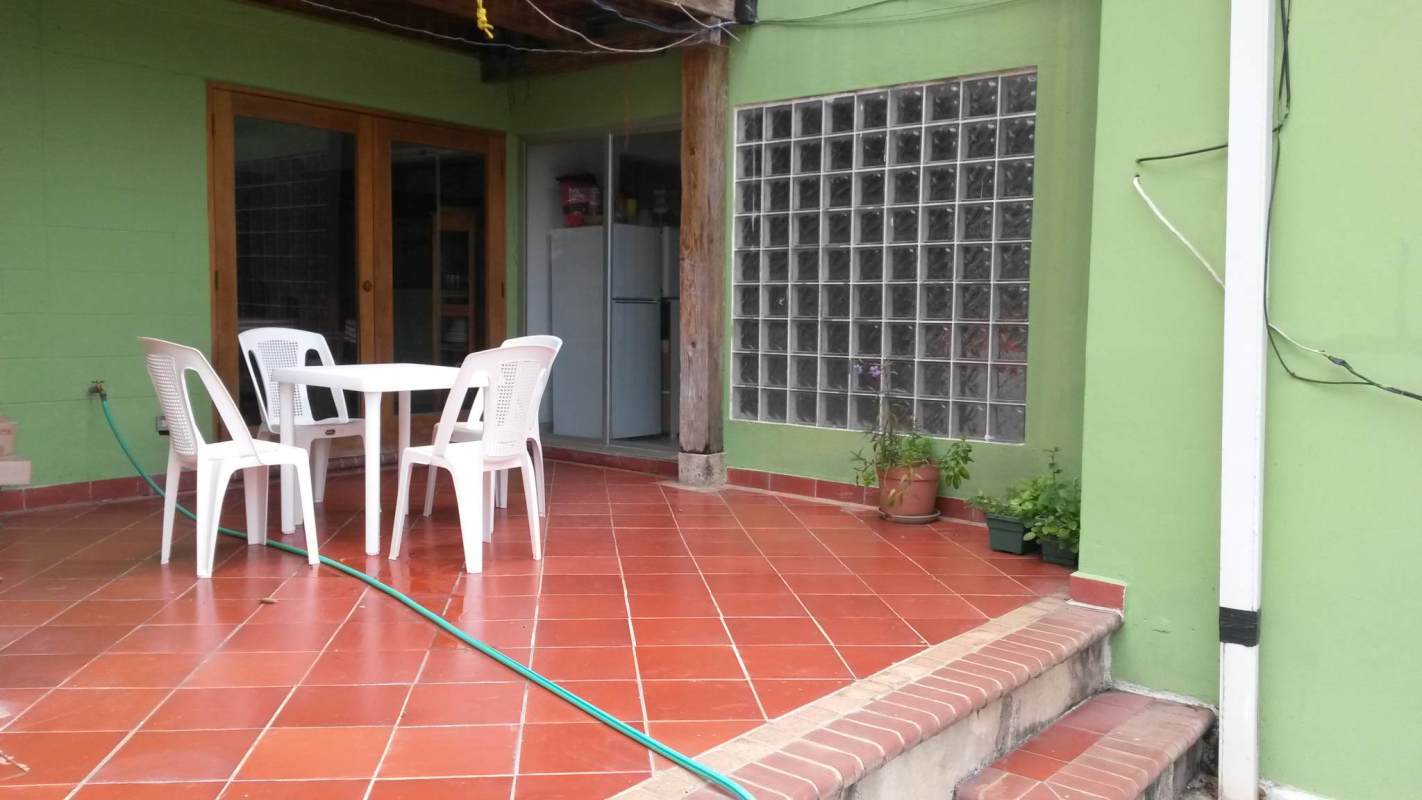 Shared outdoor terrace area with plants and green space in Clayton Panama