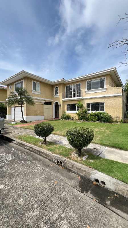 Large open living room with chandelier tile flooring and natural light in Costa Dorada house Panama