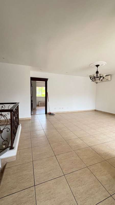 Kitchen with granite tops, wood cabinetry and large windows in luxury Costa Dorada house Panama