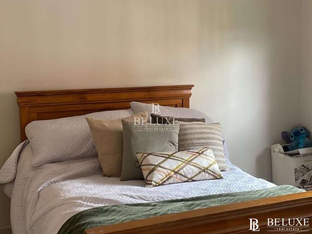 Family room with large sectional sofa and TV in Clayton Village house Panama