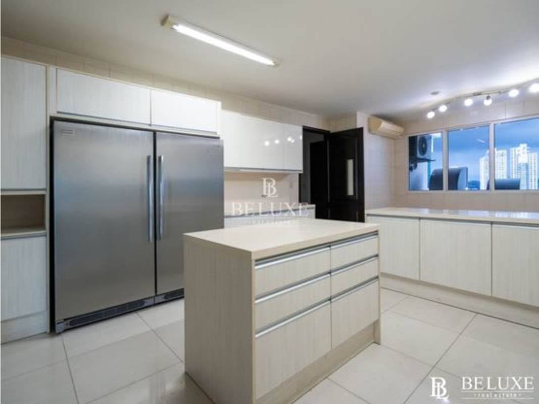 Spacious modern kitchen with island and stainless appliances in PH Zeus Costa del Este Panama City