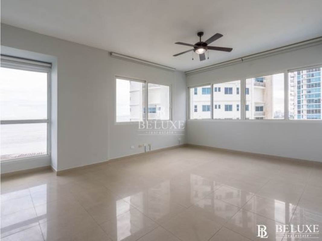 Modern spacious living room with marble flooring and floor to ceiling Pacific Ocean view at PH Zeus Costa del Este Panama