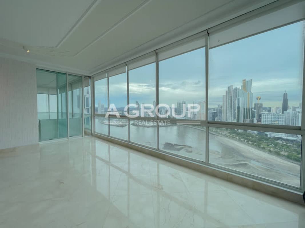 Large living dining area marble floors floor-to-ceiling windows ocean view PH Punta Roca Punta Paitilla Panama