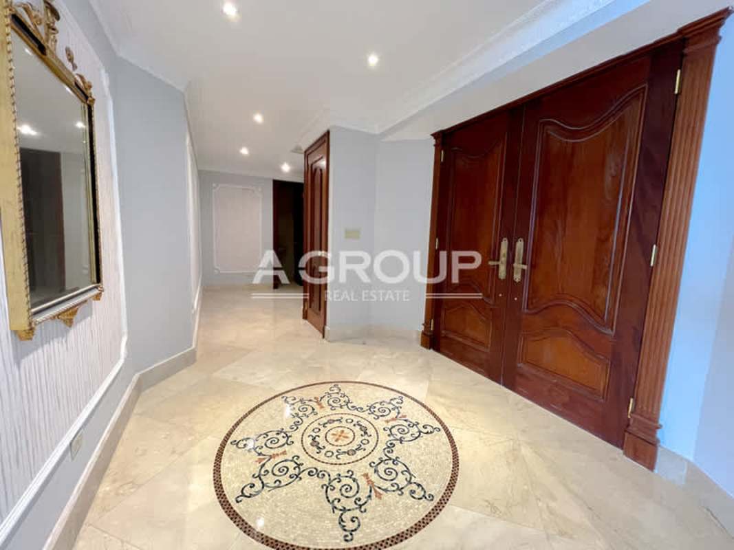 Spacious walk-in closet built-in shelving drawers beige marble floor PH Punta Roca Panama