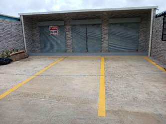 Parking spaces in front of commercial unit with yellow markings in Costa Verde La Chorrera