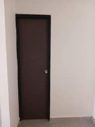 Simple interior with brown door white walls tiled floor in Costa Verde La Chorrera