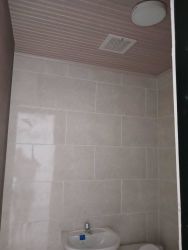 Minimalist bathroom with sink and toilet tiled walls Costa Verde La Chorrera
