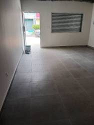 Bright open interior with large shuttered window tiled floors Costa Verde La Chorrera