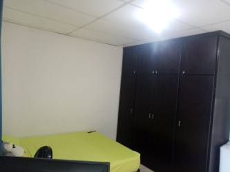 Simple bedroom with large closet, tile floor, white walls in La Herradura affordable apartment rental Panama Oeste