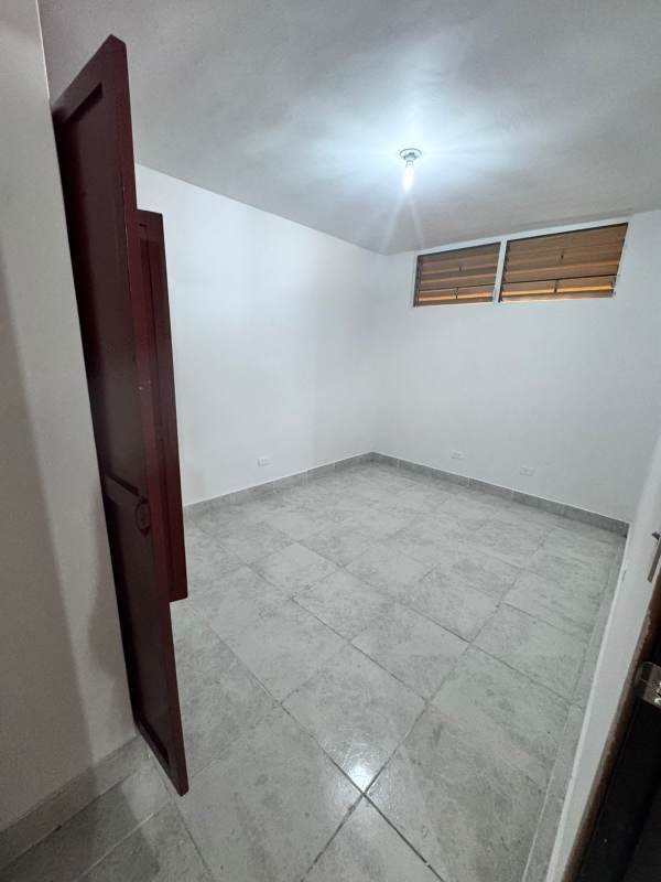 Minimal bedroom with white walls, windows and tile floor at PH El Ingenio Panama City