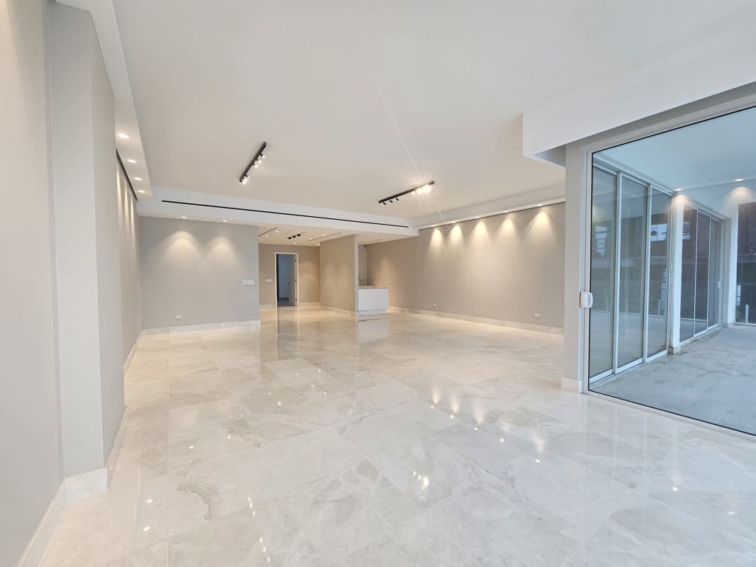 Expansive living room with floor-to-ceiling windows and terrace overlooking Pacific Ocean in PH Waterfront Panama