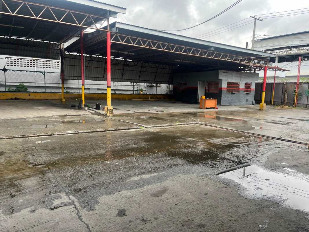 Open roofed industrial yard with concrete flooring and chain-link fence Pedregal Panama