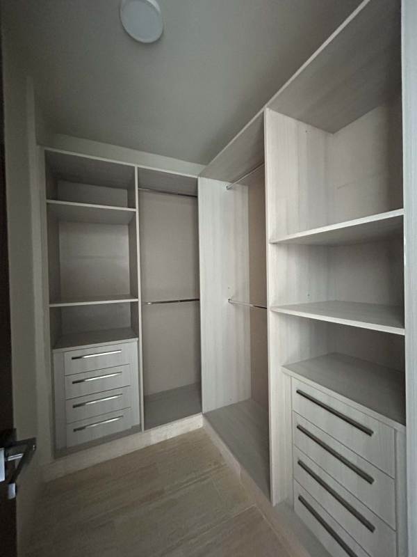 Walk-in closet with built-in shelves and drawers in luxury apartment PH The Regent Costa del Este Panama