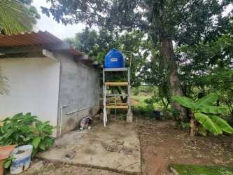 Wide porch with columns overlooking big lawn and mature trees at house in La Paz Chame