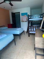 Bedroom with bunk bed, two singles, desk, AC unit Casa del Mar Hotel Pedasi Panama