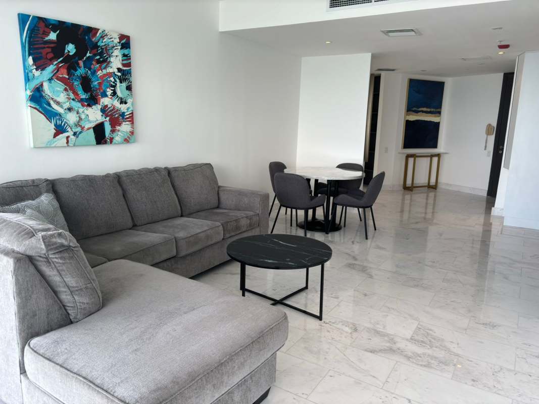 Bedroom with workspace, large windows, city skyline view in luxury Punta Pacífica apartment