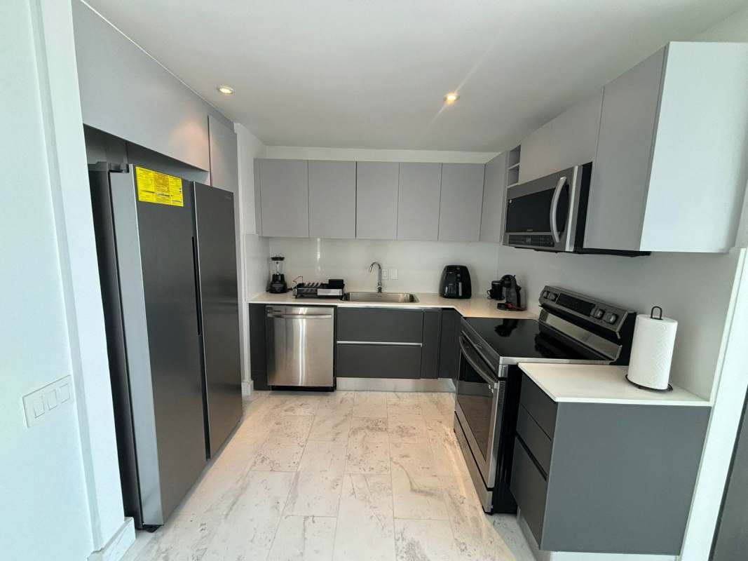 Glass balcony with tile floors, skyline views, outdoor seating at Punta Pacífica luxury condo