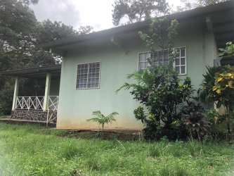 Side walkway beside country house with gardens and plants in Altos de Capira Panama