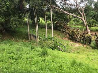 Covered entry porch with metal railing in countryside cottage Capira Panama
