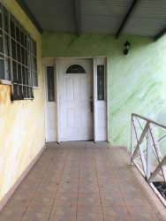 Rustic utility shed with light blue walls in rural Capira Panama country home