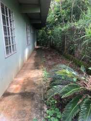 View of outdoor utility sink and garden area beside countryside home in Capira Panama